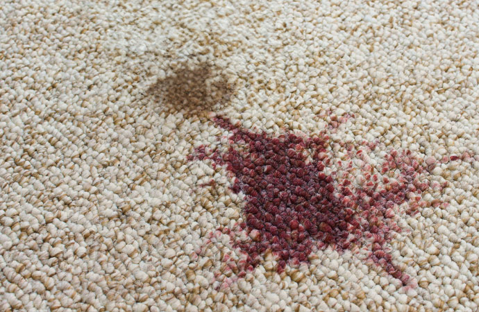 a rug with deep red beet stains, showcasing the need for effective stain removal.