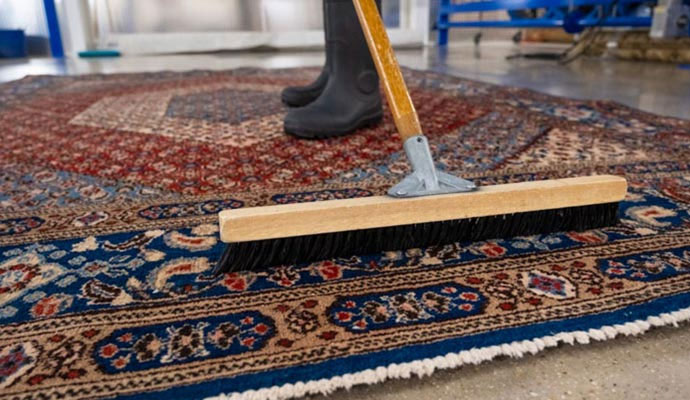 Professional worker deep cleaning a rug.