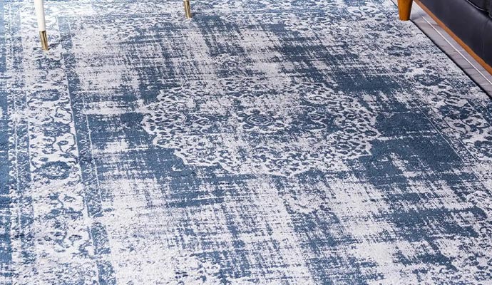 Distressed rug on floor cleaned with hot water
