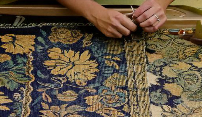 Professional trimming rug fibers during repair