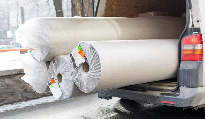 Rolled rug on the car for delivery