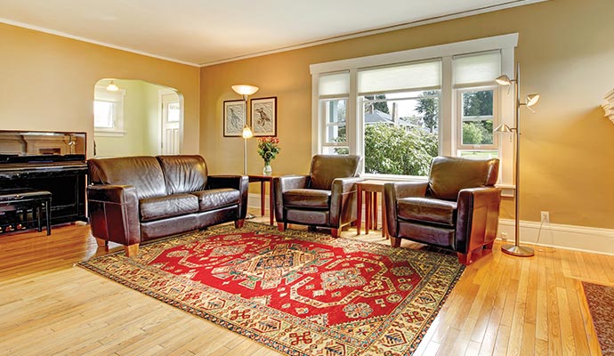 A beautiful rug is placed in a living room.