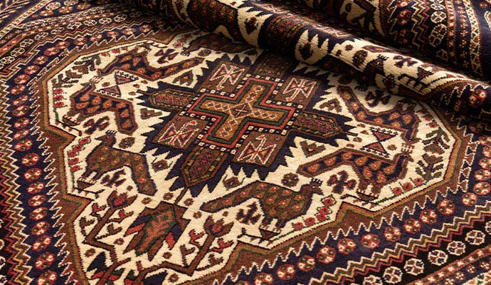 Traditional oriental area rug featuring intricate geometric patterns and decorative woven textile design