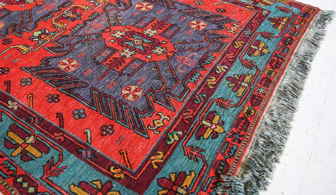 Traditional Turkish rug with geometric patterns and bold red and teal colors