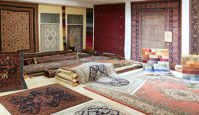 a spacious room with a lot of dyed rugs